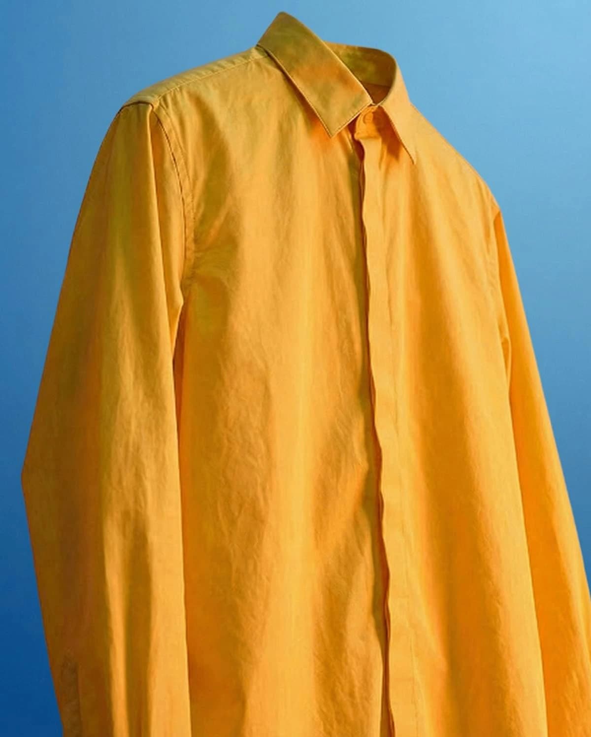 Leonardo AI generated image of a bright yellow button-up shirt against a vibrant blue background.