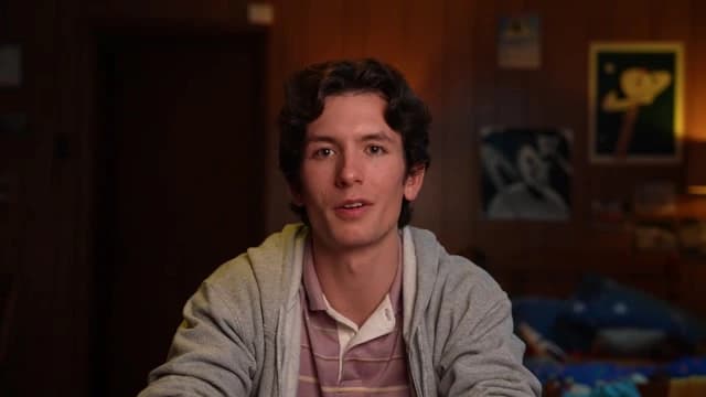 Tavus output sample showing a young man delivering a personalized video message with a friendly expression.