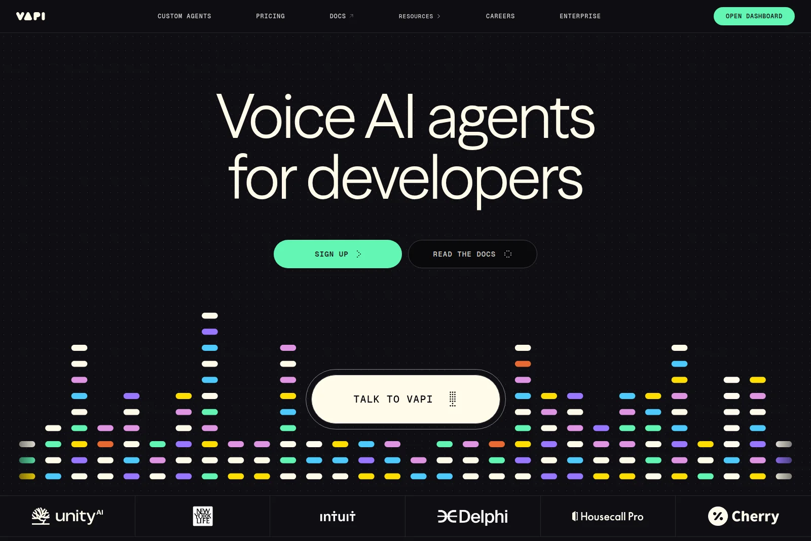Vapi homepage hero section featuring 'Voice AI agents for developers' headline, call-to-action buttons, and an interactive audio visualization.